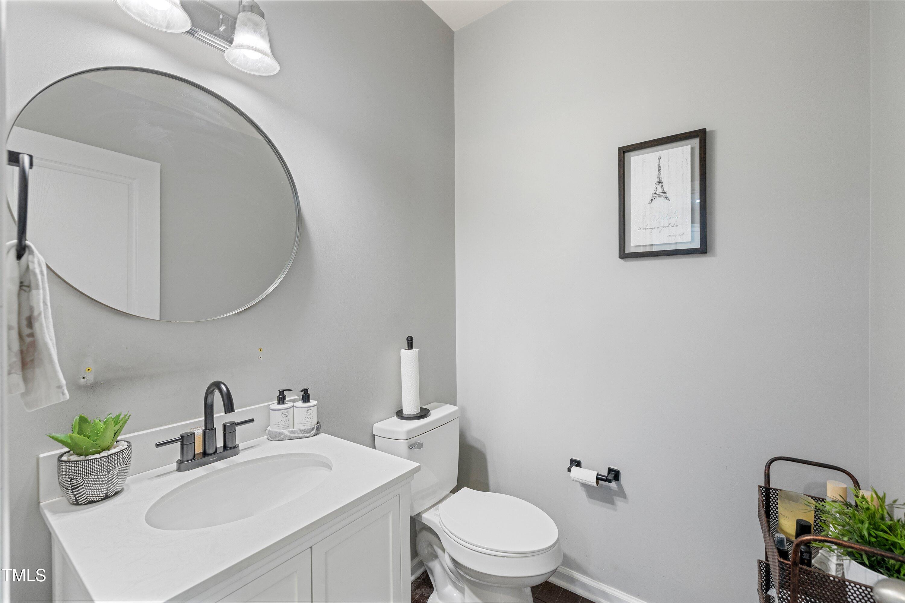 9352 Wooden Road Raleigh, NC 27617 - Photo 12 of 43 a bathroom with a toilet a sink and mirror