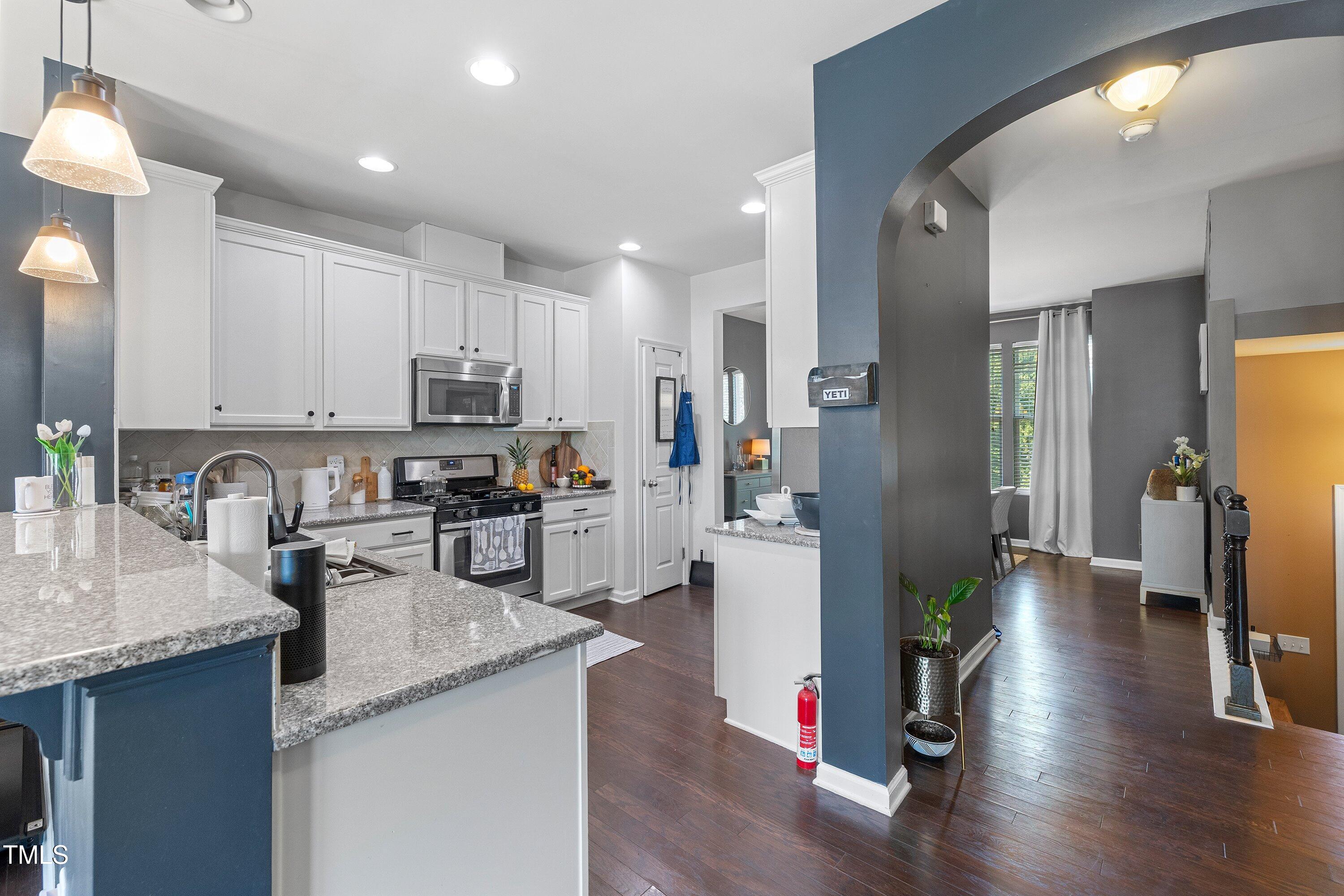 9352 Wooden Road Raleigh, NC 27617 - Photo 14 of 43 a kitchen with granite countertop a refrigerator stove top oven and sink