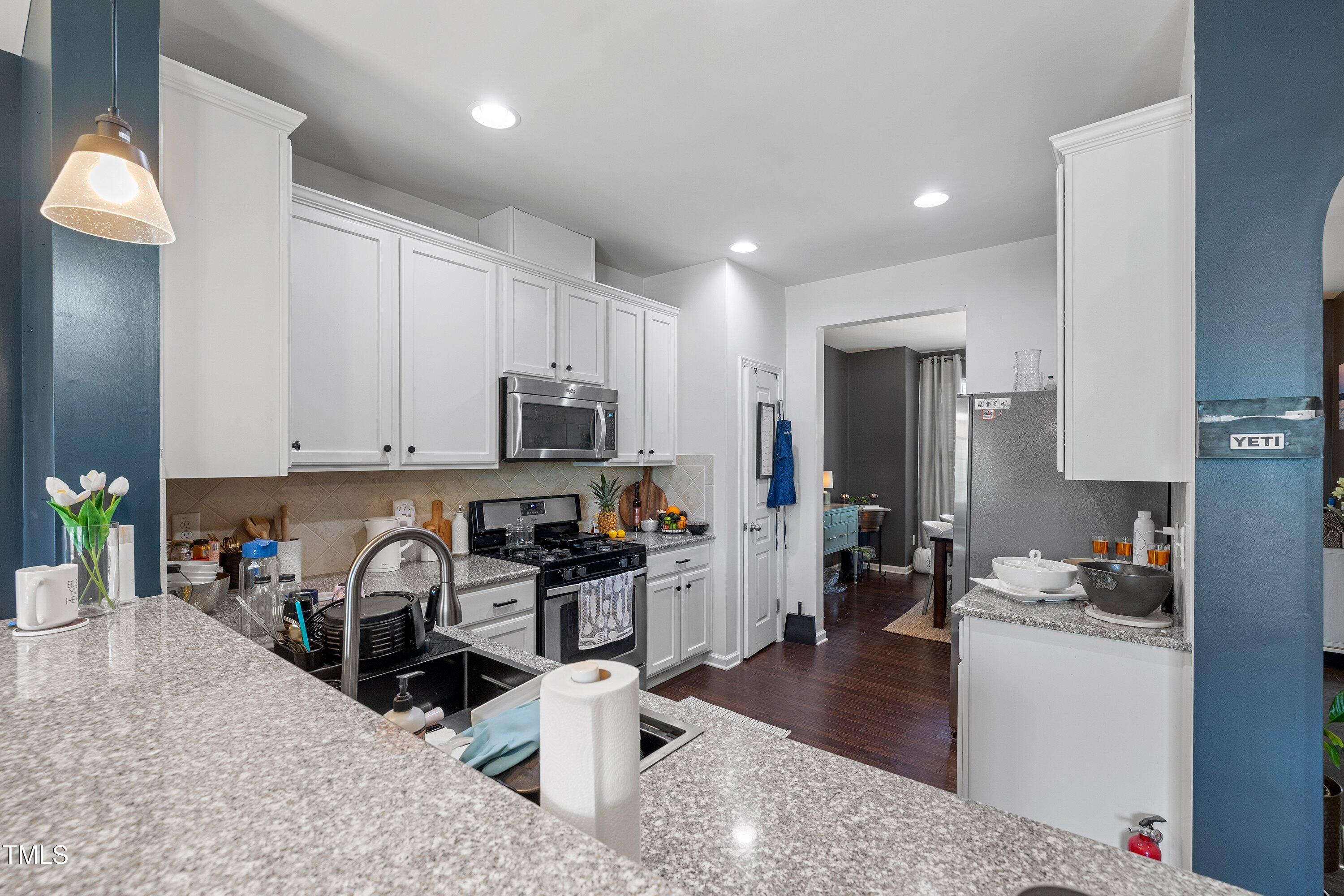 9352 Wooden Road Raleigh, NC 27617 - Photo 15 of 43 a kitchen with sink a stove and cabinets