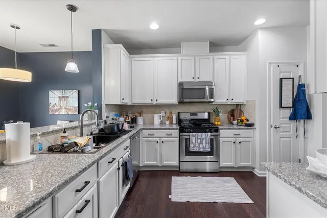 a kitchen with a sink stove and refrigerator