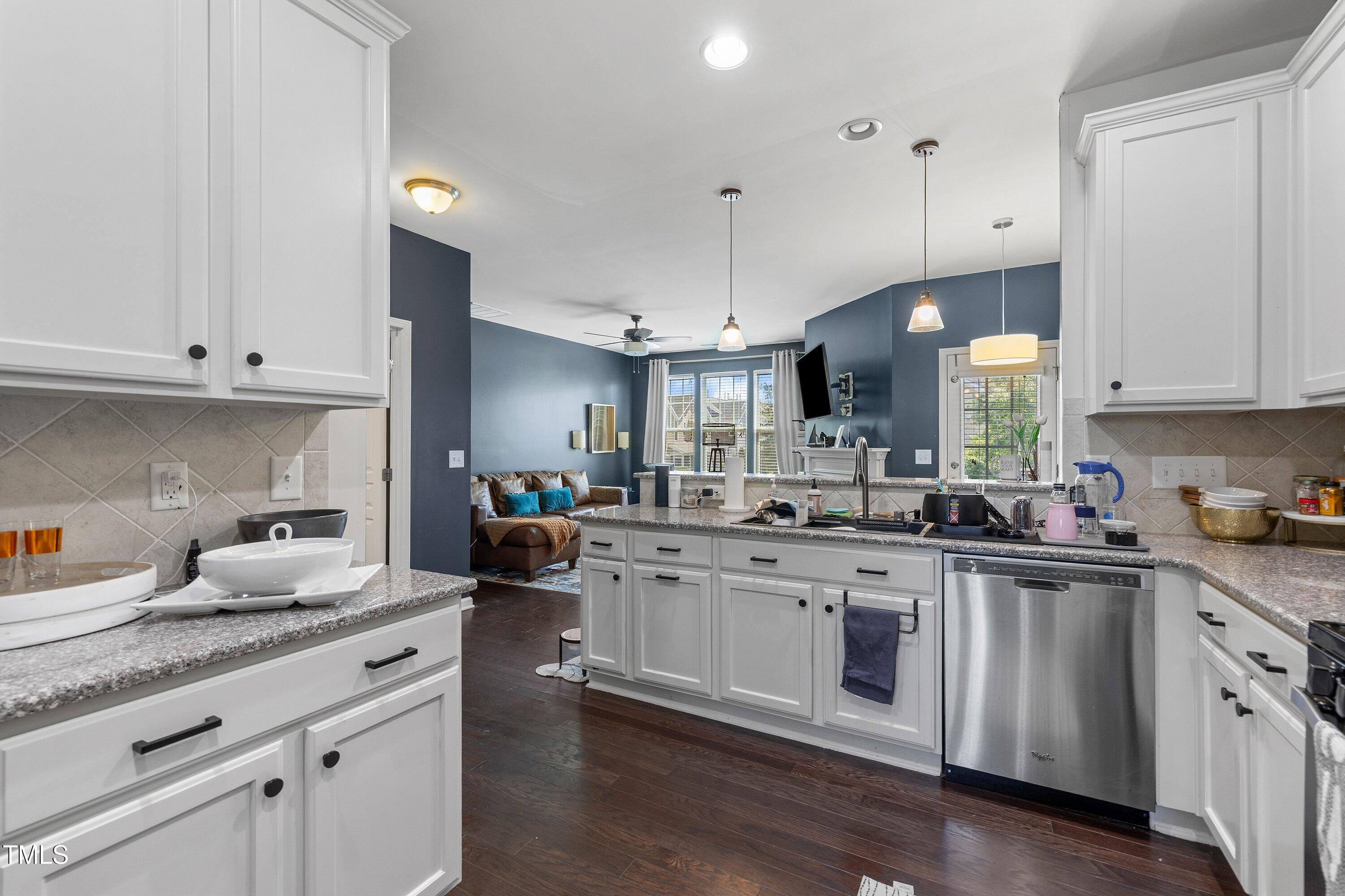 9352 Wooden Road Raleigh, NC 27617 - Photo 18 of 43 a kitchen with white cabinets and sink