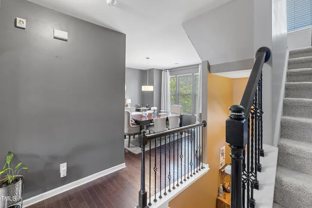 a view of a hallway with wooden floor and entryway