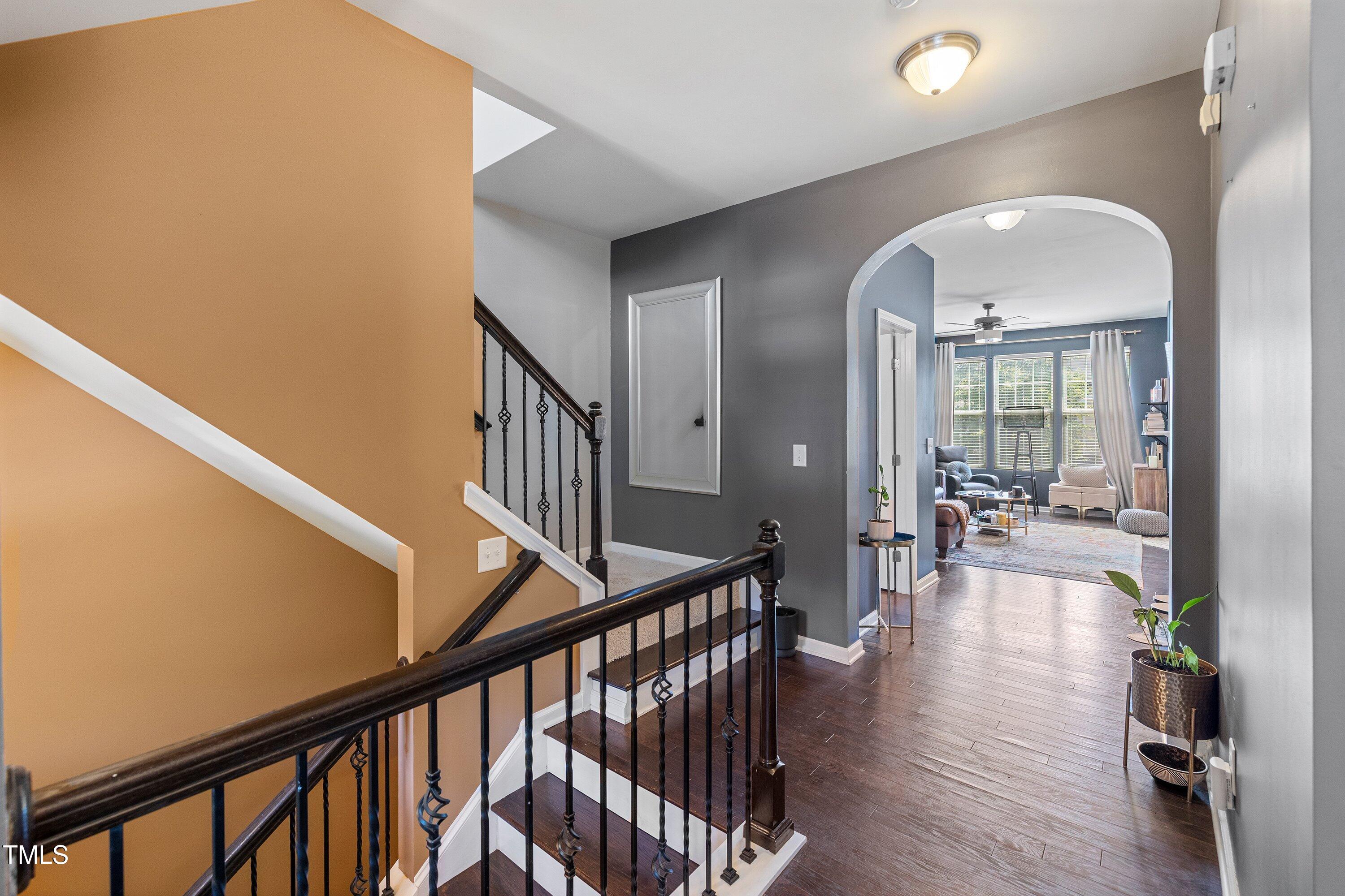 9352 Wooden Road Raleigh, NC 27617 - Photo 24 of 43 a view of livingroom with hardwood floor and stairs
