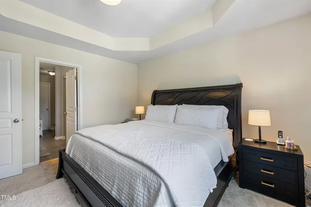 a bedroom with a bed and a night stand