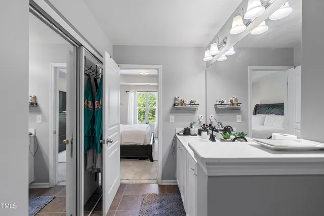 a bathroom with a sink a large mirror and shower