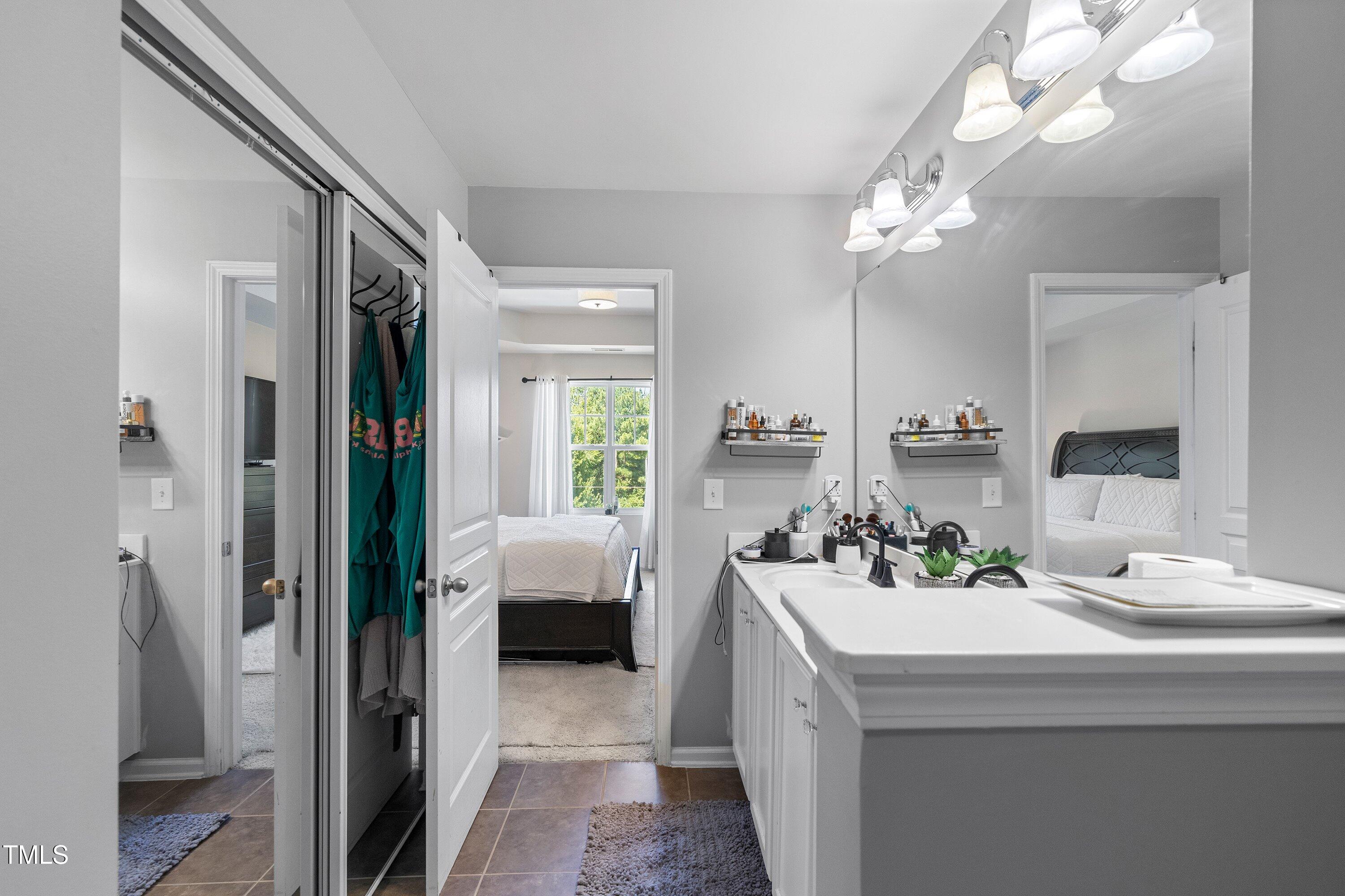 9352 Wooden Road Raleigh, NC 27617 - Photo 28 of 43 a bathroom with a sink a large mirror and shower