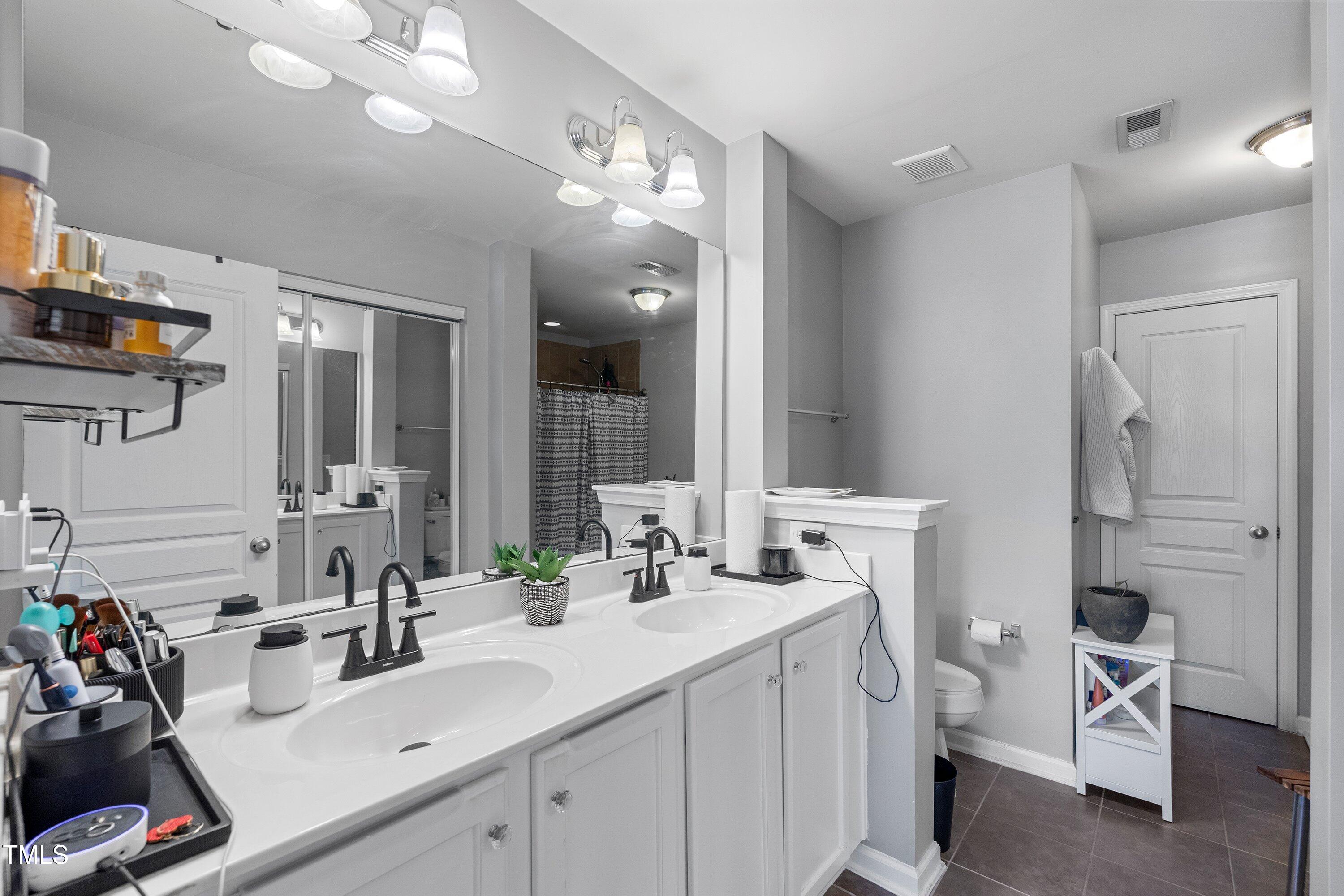 9352 Wooden Road Raleigh, NC 27617 - Photo 29 of 43 a bathroom with a sink double vanity and a mirror