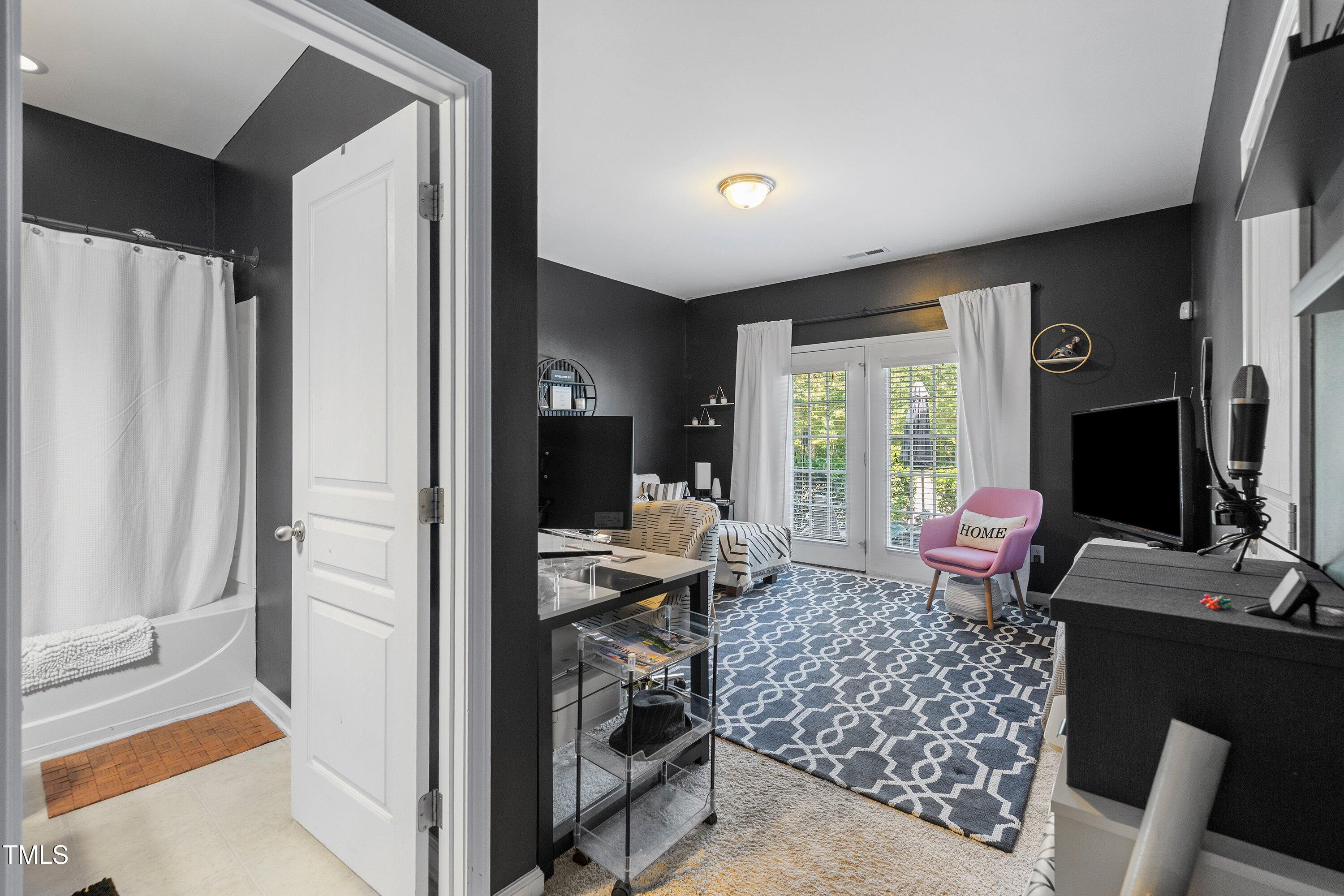 9352 Wooden Road Raleigh, NC 27617 - Photo 30 of 43 a living room with furniture and a flat screen tv