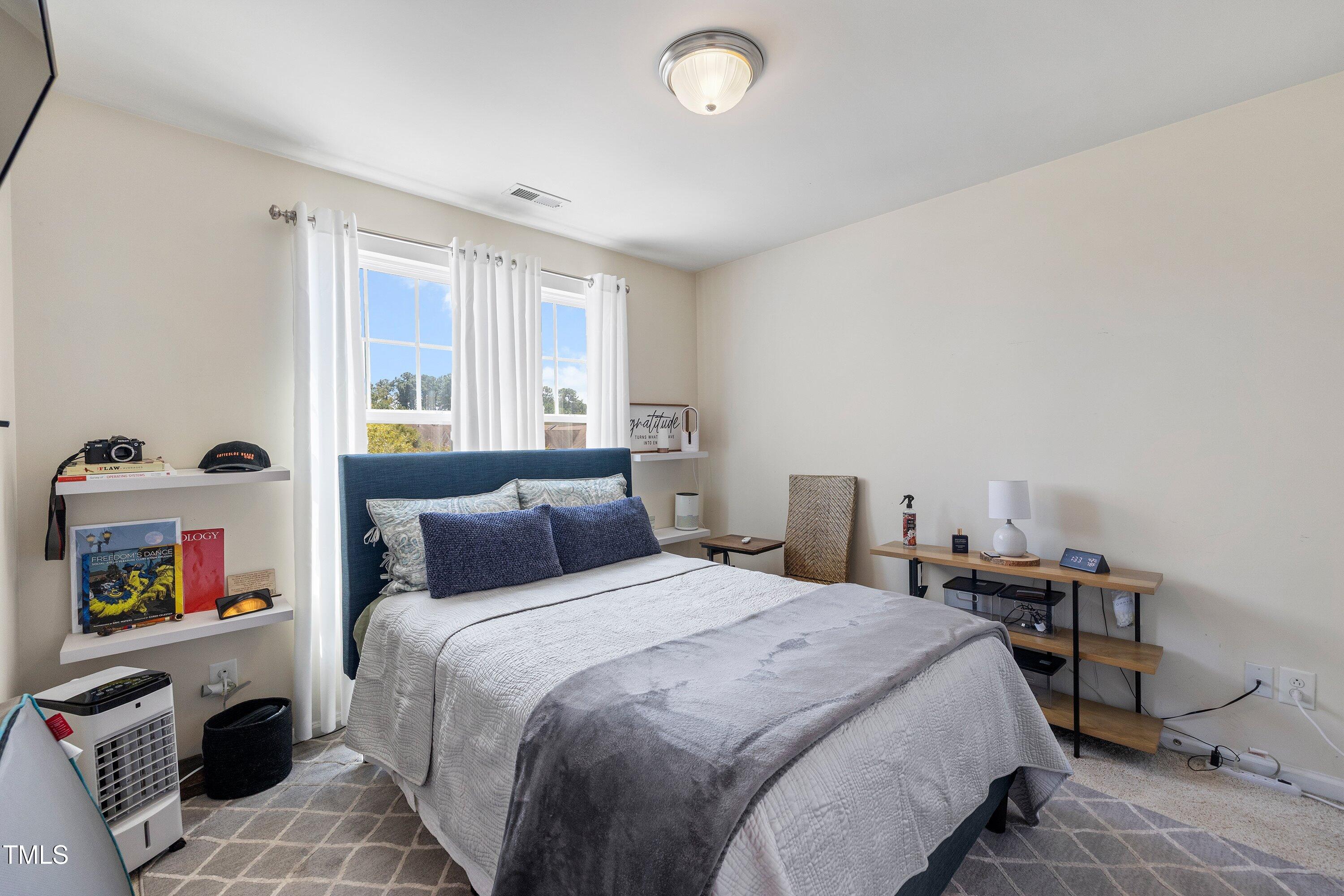 9352 Wooden Road Raleigh, NC 27617 - Photo 34 of 43 a bedroom with a bed and a window