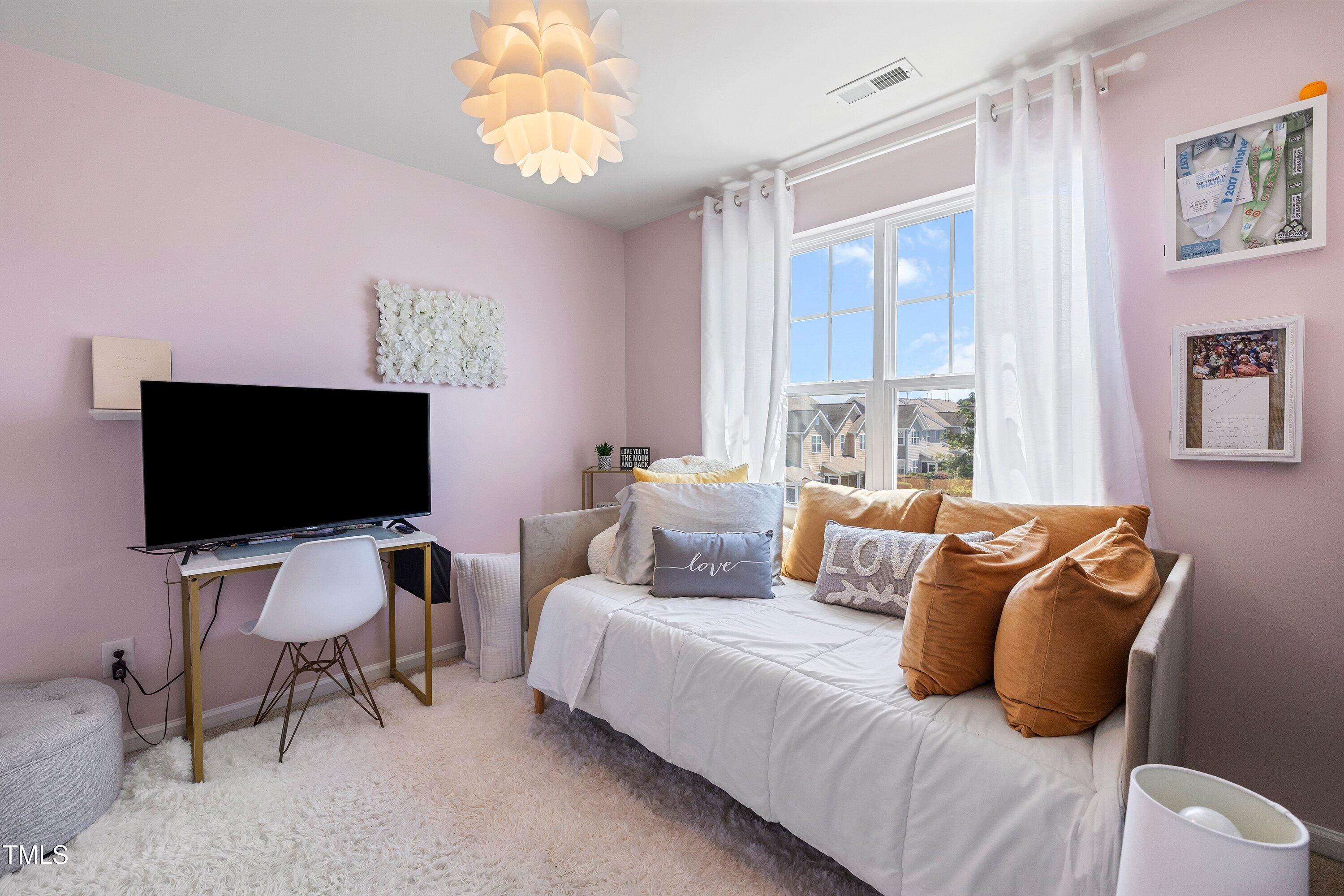 9352 Wooden Road Raleigh, NC 27617 - Photo 37 of 43 a living room with furniture and a flat screen tv
