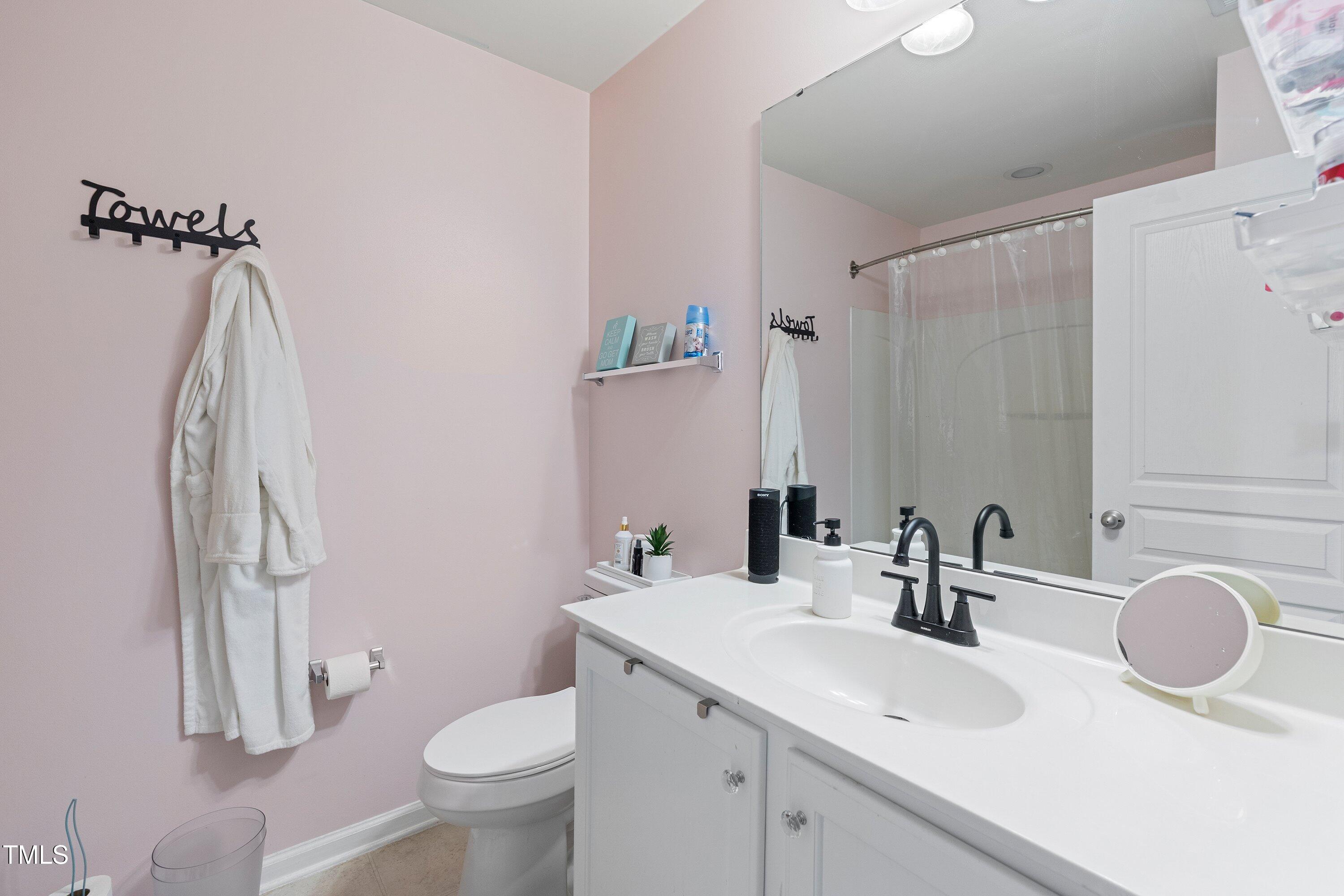 9352 Wooden Road Raleigh, NC 27617 - Photo 39 of 43 a bathroom with a sink toilet and shower