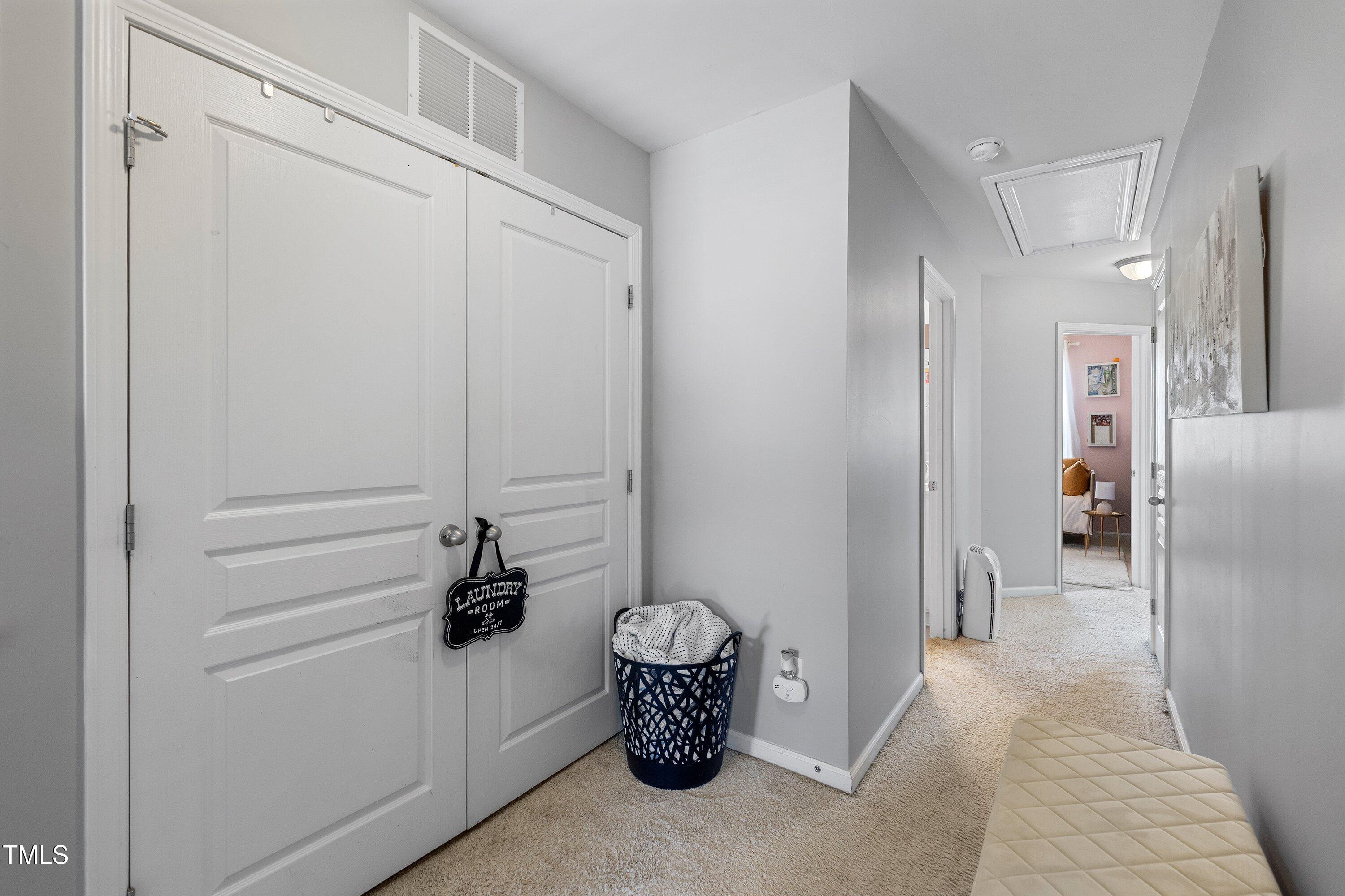9352 Wooden Road Raleigh, NC 27617 - Photo 40 of 43 a hallway with a dining table and chairs