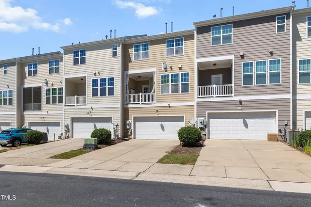 a front view of a house with a yard and a garage