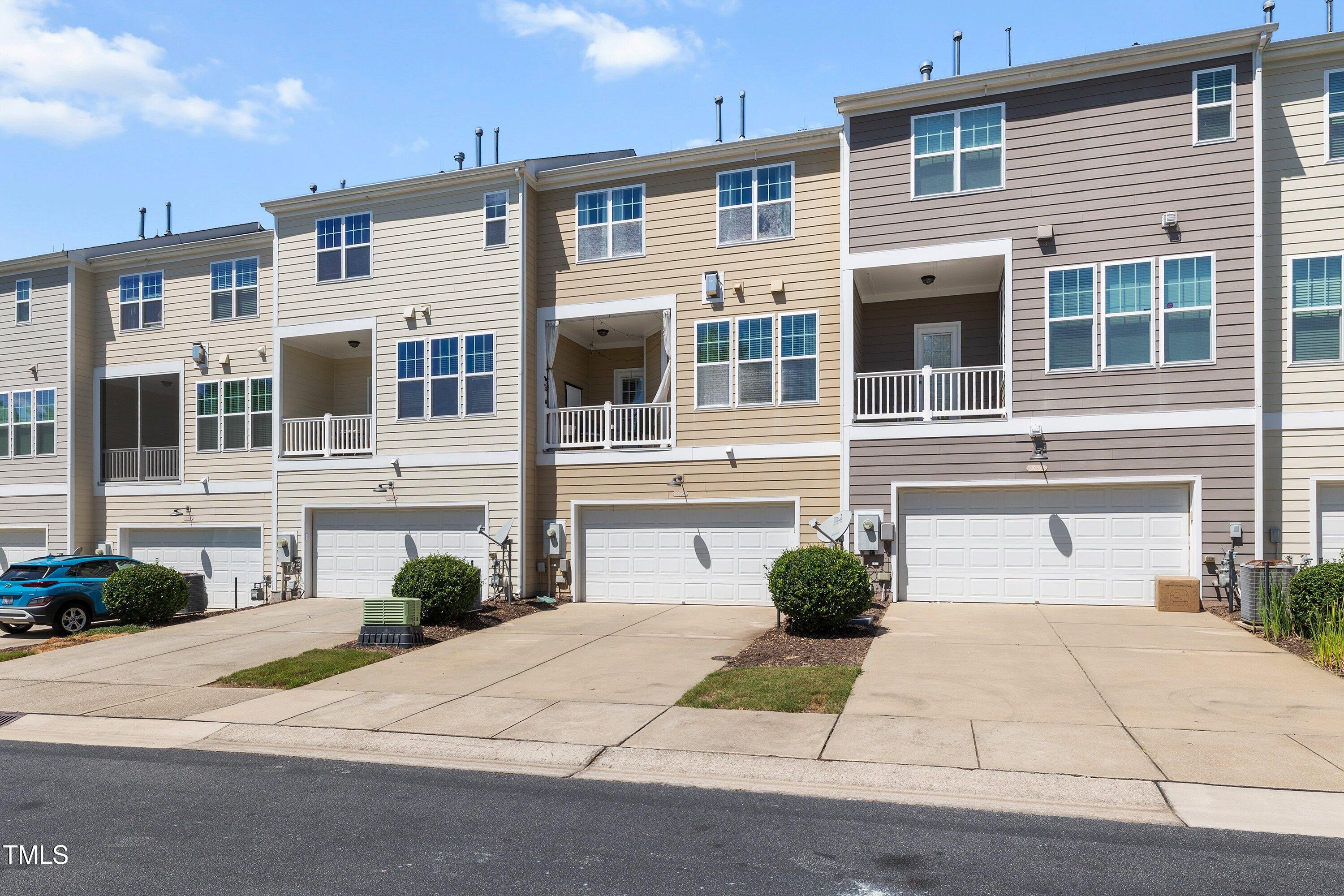 9352 Wooden Road Raleigh, NC 27617 - Photo 42 of 43 a front view of a house with a yard and a garage