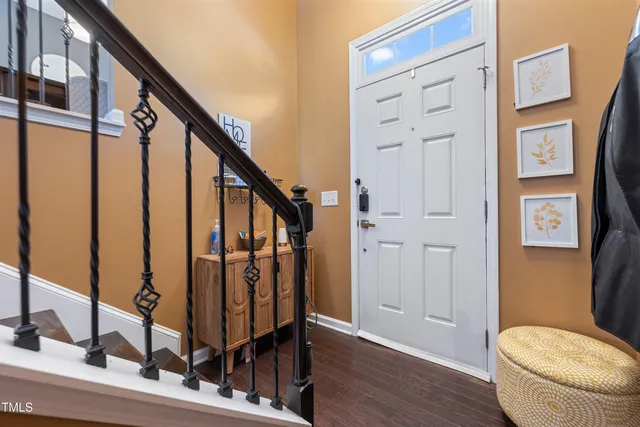 a view of entryway with wooden floor and stairs