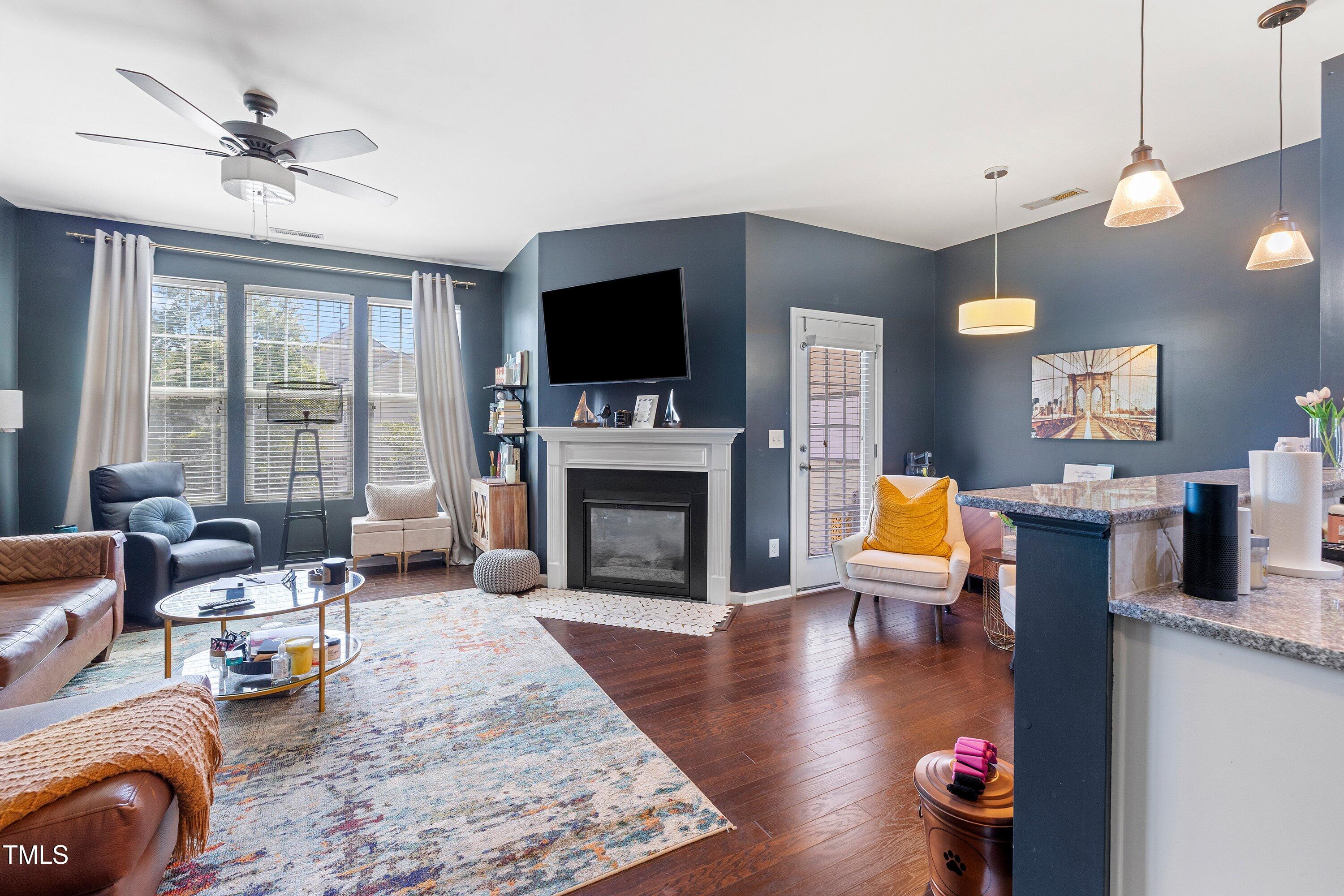 9352 Wooden Road Raleigh, NC 27617 - Photo 7 of 43 a living room with furniture fireplace and a flat screen tv