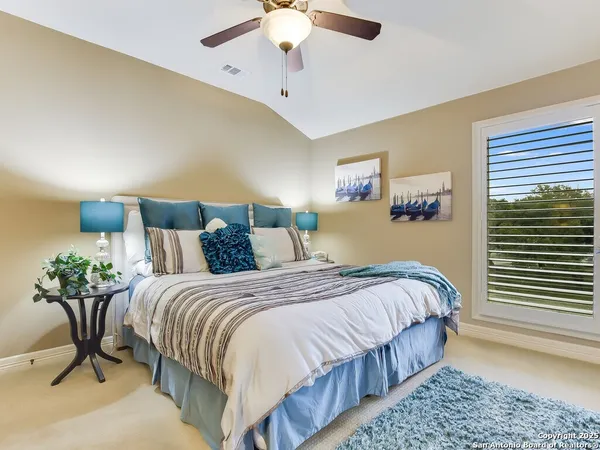 a bedroom with bed and a chandelier