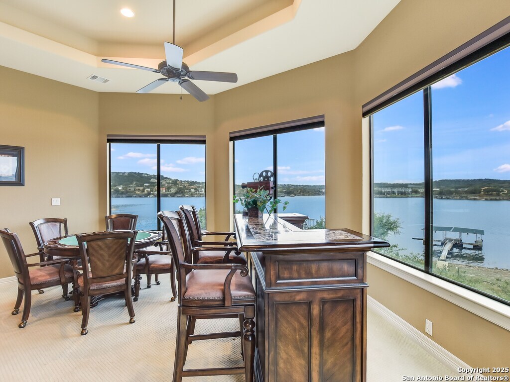 21913 Mockingbird Street Lago Vista, TX 78645 - Photo 20 of 39 a view of a dining room with furniture large windows and wooden floor