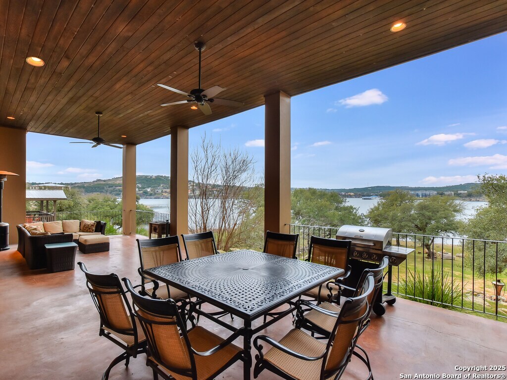 21913 Mockingbird Street Lago Vista, TX 78645 - Photo 28 of 39 a view of a patio with a table chairs and a swimming pool