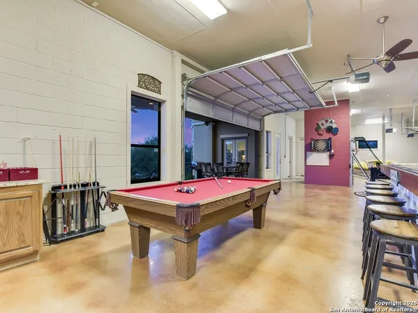 a room with pool table and a flat screen tv