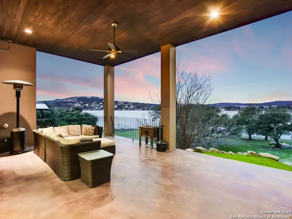 a living room with patio furniture and a floor to ceiling window