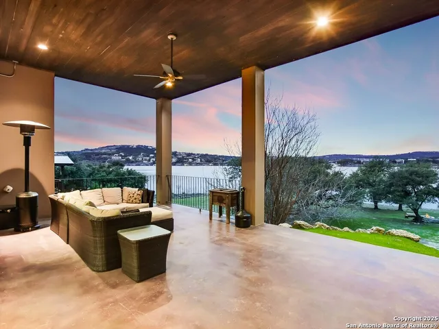 a living room with patio furniture and a floor to ceiling window