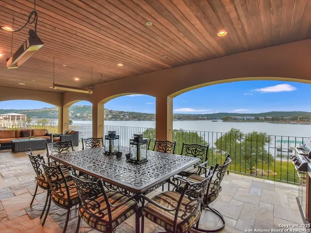 a dining room with furniture and a floor to ceiling window