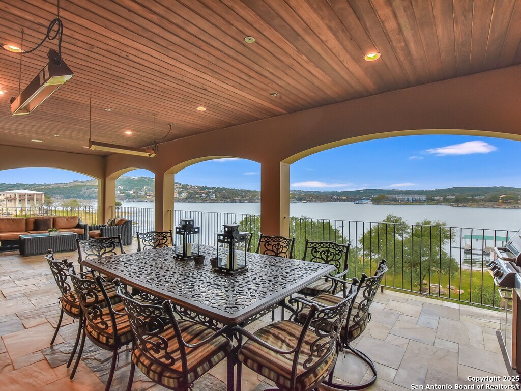 21913 Mockingbird Street Lago Vista, TX 78645 - Photo 37 of 39 a dining room with furniture and a floor to ceiling window