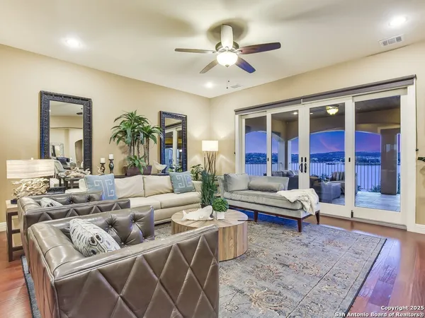 a living room with furniture ceiling fan and a rug