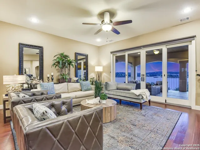 a living room with furniture ceiling fan and a rug