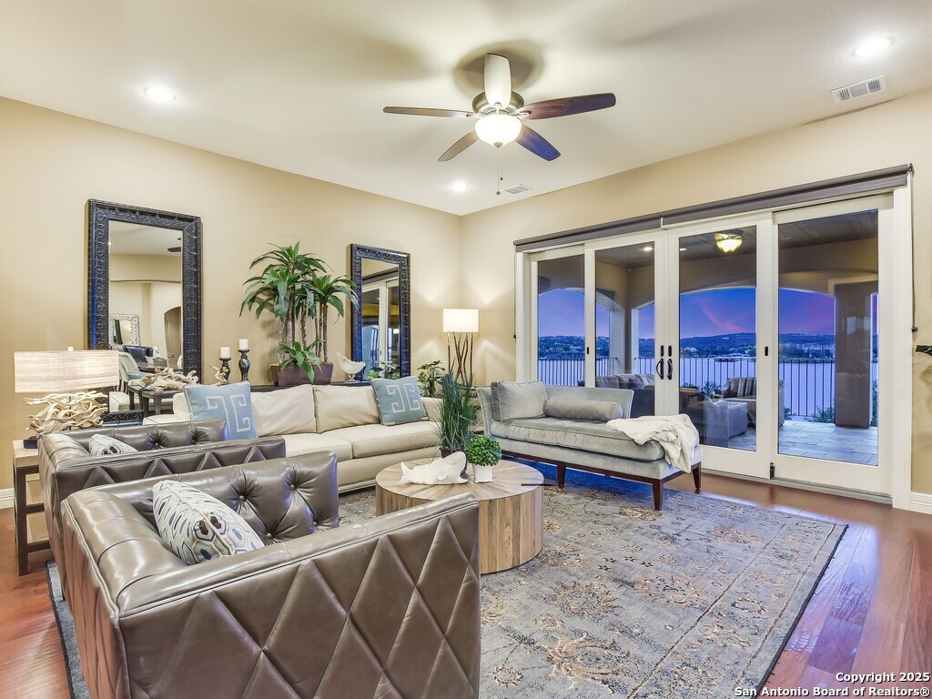 21913 Mockingbird Street Lago Vista, TX 78645 - Photo 5 of 39 a living room with furniture ceiling fan and a rug