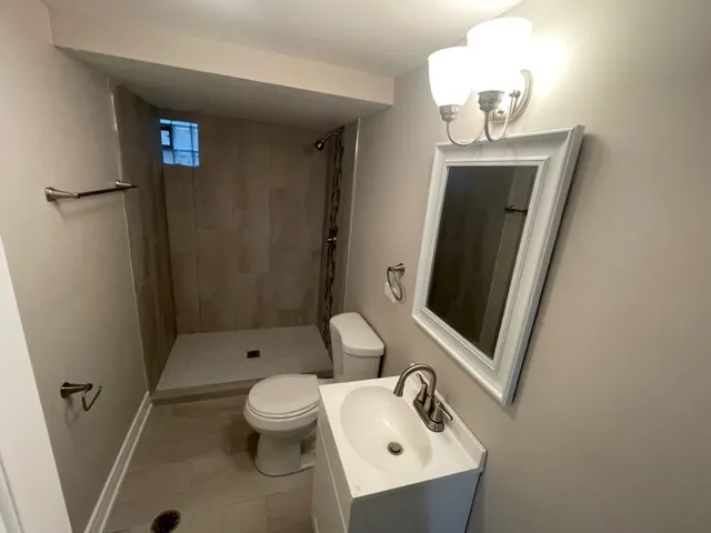 a bathroom with a sink toilet and shower