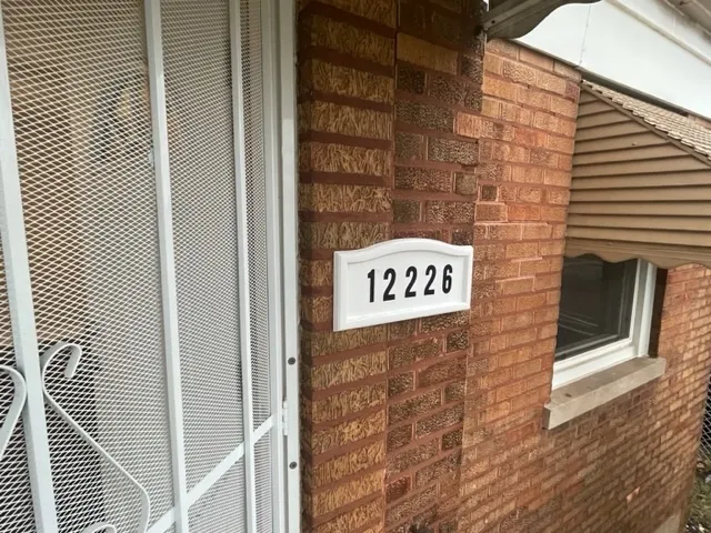 a sign that is on a brick wall