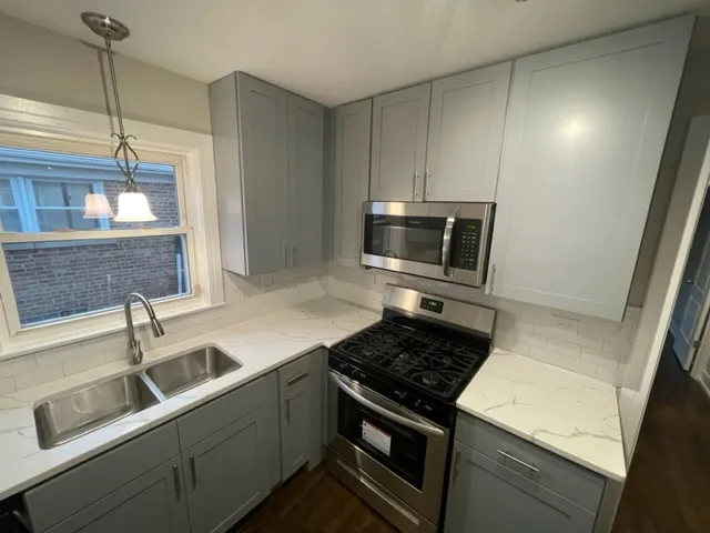 a kitchen that has a sink and a stove