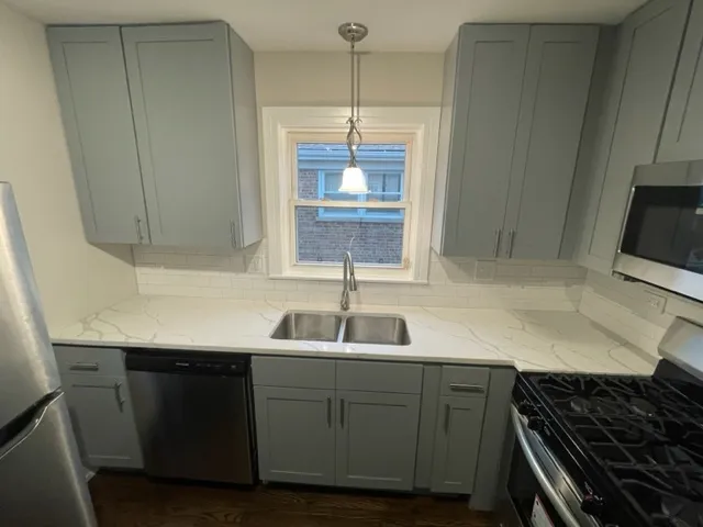 a kitchen with a sink and a refrigerator