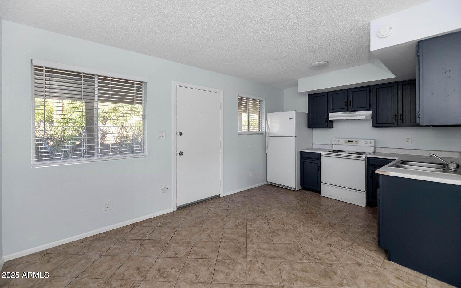 822 East Carol Avenue Phoenix, AZ 85020 - Photo 7 of 25 a kitchen with a stove a sink and a microwave