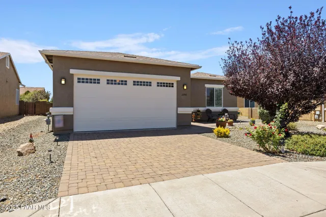 an aerial view of a house with a garden and mountains