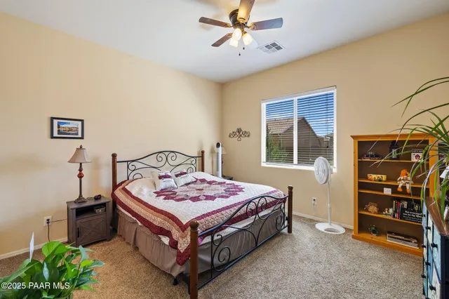 a bedroom with a bed and flat screen tv