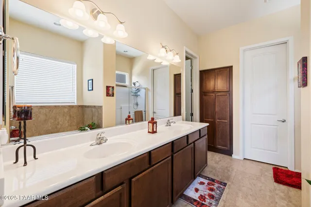 a white bath tub sitting in a bathroom next to a window