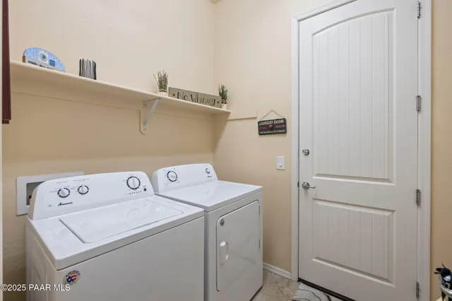 a view of a patio with couches table and chairs under an umbrella with a fire pit