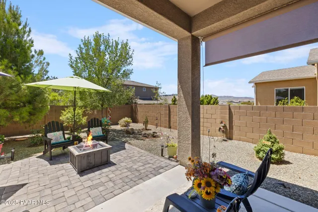 a view of a house with backyard and sitting area