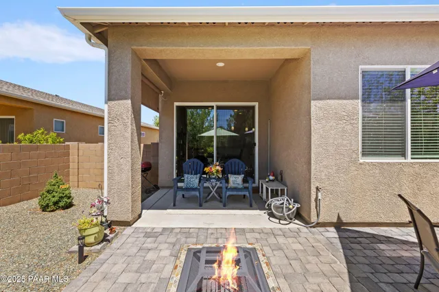 a white house with a tree in the background