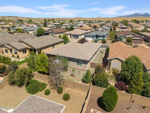 an aerial view of residential houses with outdoor space and street view