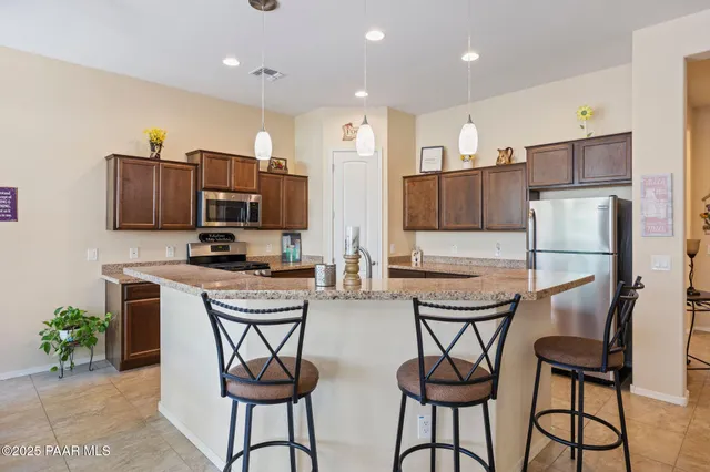 a kitchen with a sink stove and refrigerator