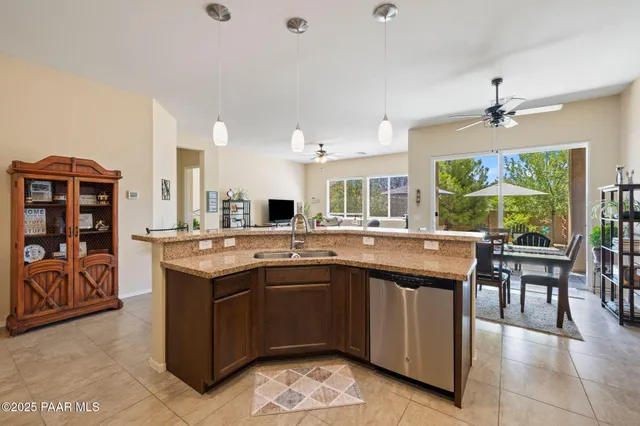 a view of a livingroom with workspace and a window