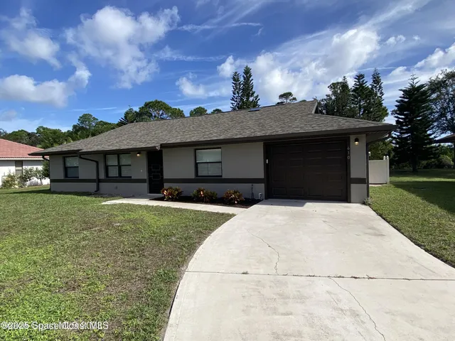 front view of a house with a garden