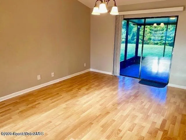 a view of empty room with floor to ceiling window