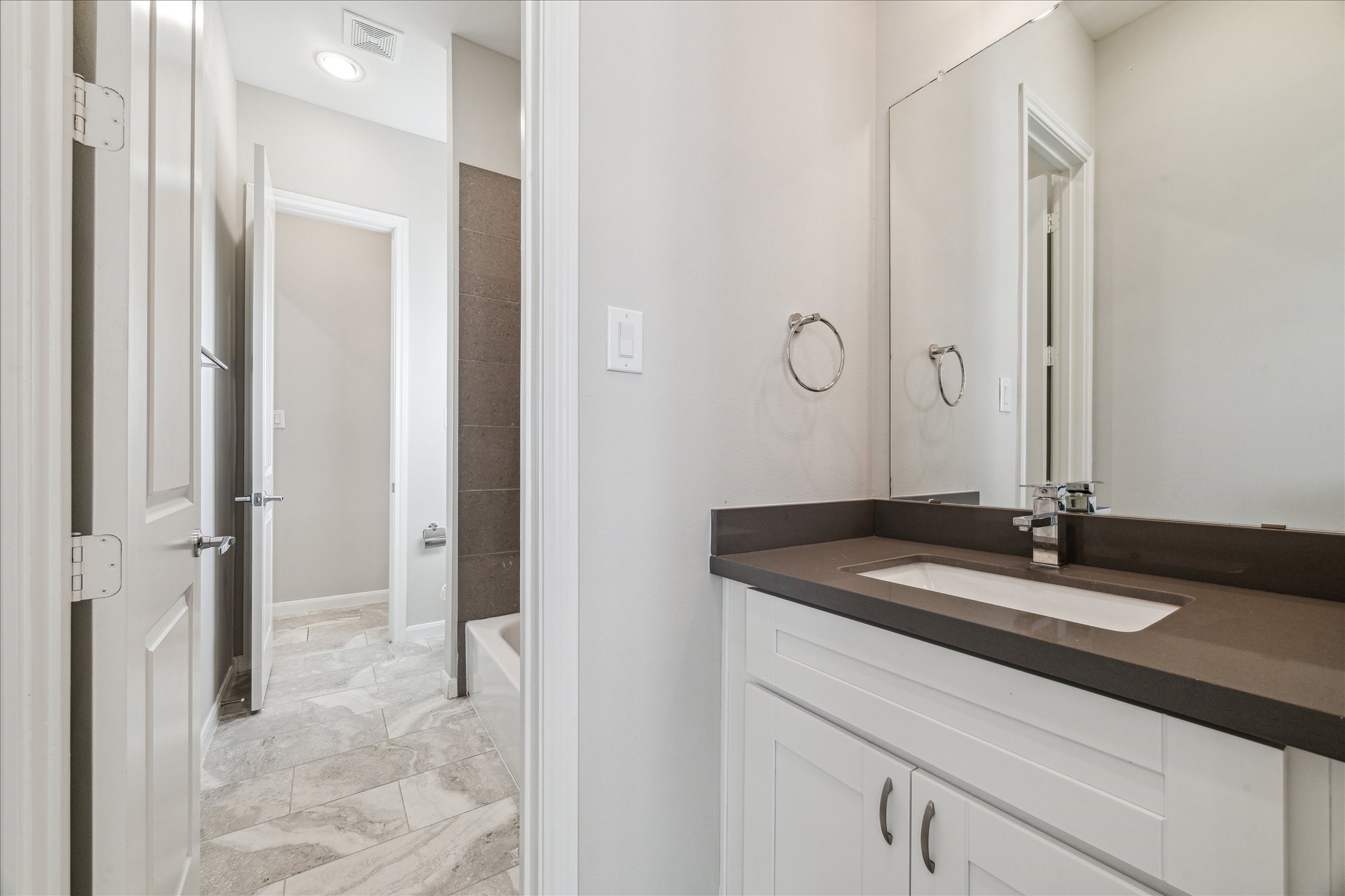 5610 Patrick Street, Unit A Houston, TX 77076 - Photo 8 of 11 a bathroom with a granite countertop sink and a mirror
