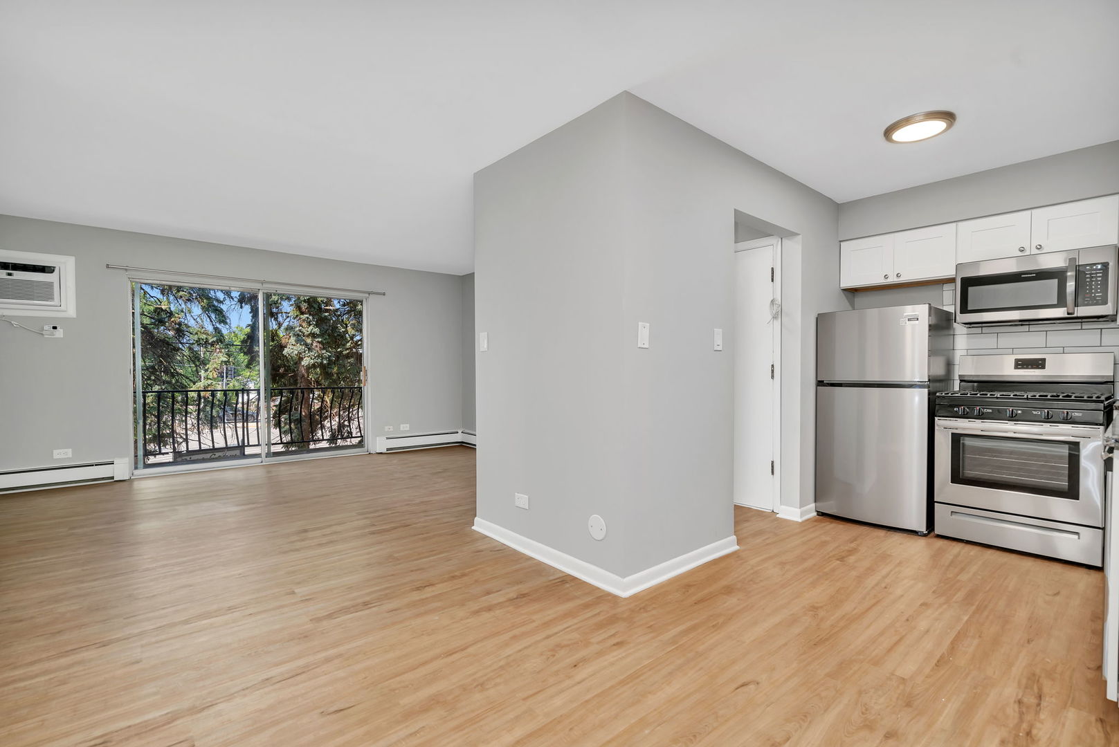 909 Plainfield Road, Unit 12 Darien, IL 60561 - Photo 7 of 10 a view of a kitchen with a stove fridge and wooden floor