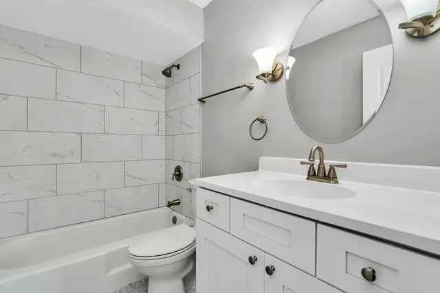 a bathroom with a sink a toilet and a mirror